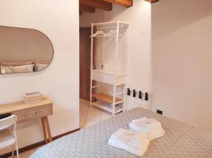 a bedroom with a bed and a desk and a mirror at CASA ALLE ERBE Prestige & Exclusive stay in Vicenza