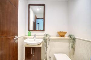 a bathroom with a sink and a mirror at The Smart Concierge - Delphine in Dubai