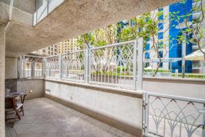 a balcony with white railing and a table and chairs at The Smart Concierge - Delphine in Dubai