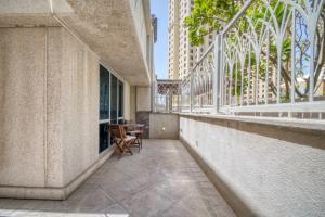 a balcony with a table and chairs in a building at The Smart Concierge - Delphine in Dubai