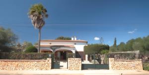 a house with a palm tree in front of it at Can Canto Mediterranea x 6 pax in Sa Ràpita +7 photos