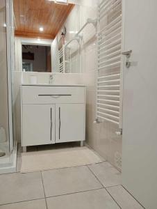 a white bathroom with a sink and a shower at Casinha das Estrelas in Cerejeira +39 photos