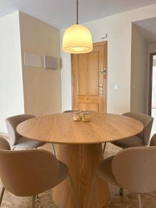 a dining room with a wooden table and chairs at Living Home - Centro Ciudad in Murcia +6 photos