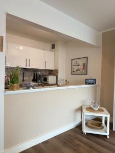 a kitchen with white cabinets and a counter at Haus Westerhörn in Westerland