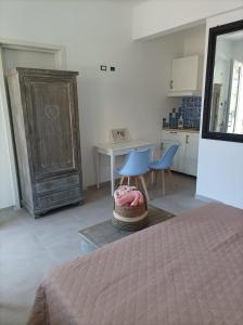 a bedroom with a bed and a table and chairs at La porta dell'eden con angolo cottura in Spotorno