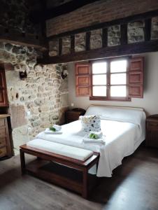 a bedroom with a large bed and a window at El Limonero in Arenas de Iguña