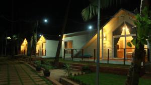 a house at night with lights on at Sea Breeze, Guhagar in Guhagar