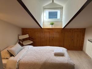 a bedroom with a large bed and a window at Vallespin Suite II in Ávila