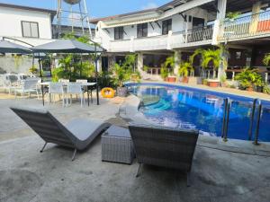 a patio with chairs and a pool in a building at Vincent Resort Hotel in Angeles