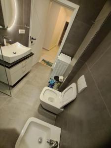 a bathroom with a sink and a toilet in it at Apartments Keesi 2 in Durrës