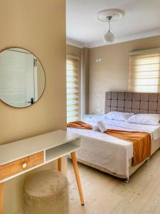 a bedroom with a bed with a mirror and a desk at Villa 77 in Kaş +46 photos