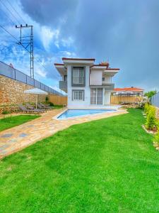 a house with a swimming pool in a yard at Villa 77 in Kaş