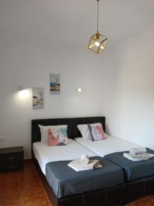 two beds sitting next to each other in a room at Daisy rooms Skiathos in Skiathos