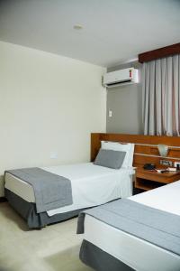Postel nebo postele na pokoji v ubytování Copas Executive Hotel