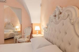 a white bedroom with a bed and a room with a bedsenalsenal at Villa La Gioconda in Neviano +31 photos