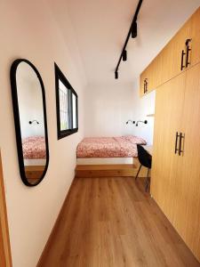 a bedroom with a bed and a mirror on the wall at Stylish loft with view and terrace Maarif Gauthier in Casablanca +25 photos