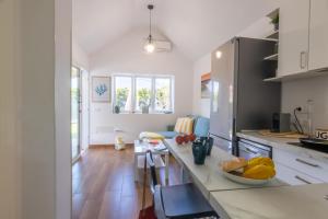 a kitchen with white cabinets and a counter top at Bungalow Playa Flor 82 by Villagrancanaria in San Bartolomé de Tirajana