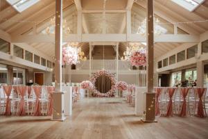 a room filled with chairs and a room with pink flowers at Marwell Hotel Winchester South in Winchester