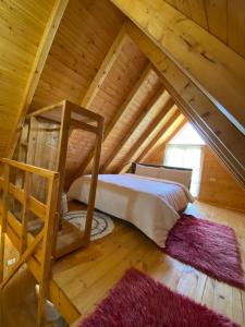 a bedroom in a log cabin with a bed and a ladder at Berat Wooden Villas with Private Pool in Berat +33 photos