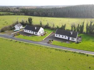 an aerial view of two white houses in a field at Cassidy Cottages 3 Bed in Cavan +9 photos