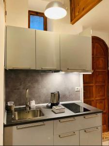 a kitchen with a sink and a counter top at Easy Suite Roma San Pietro in Rome +20 photos