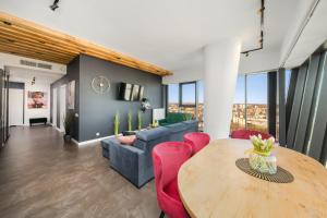 a living room with a table and a couch at Hanza Tower Apartment no 2210 - 22nd floor, swimming pool, jacuzzi, panorama view in Szczecin