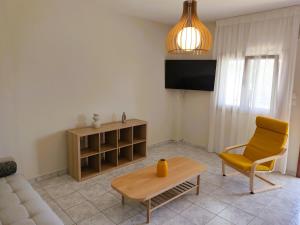 a living room with a couch and a chair and a table at Mellonia in Nikiti