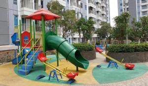a playground with a slide in a park at Pakuwon Orchard Tanglin Surabaya in Surabaya