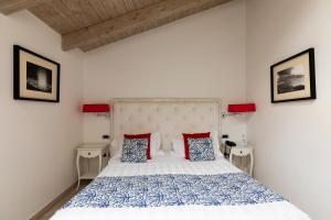 a bedroom with a bed with two night stands and two lamps at La Ciliegina Lifestyle Hotel in Naples