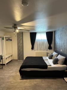 a bedroom with a large bed and a ceiling at Mikroapartments Klarenthal in Saarbrücken