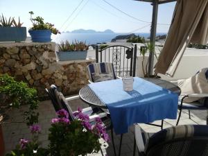 a table and chairs on a patio with a view of the ocean at Le Case dei pescatori - Sirena in Arcipelago Ponziano