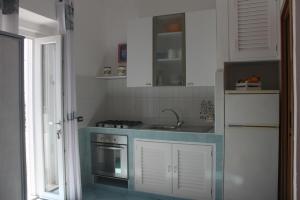 a kitchen with a sink and a stove at Le Case dei pescatori - Sirena in Arcipelago Ponziano +9 photos