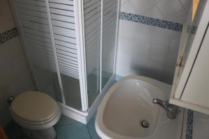 a bathroom with a shower and a toilet and a sink at Le Case dei pescatori - Sirena in Arcipelago Ponziano