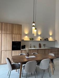 a dining room with a wooden table and chairs at Vila Espinosa in Pridvorci