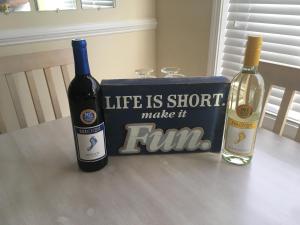 two bottles of wine and a box with a sign at Relax, Beach, Golf, Shop, Repeat resort in Calabash