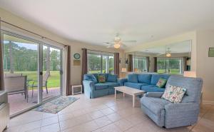 a living room with a blue couch and chairs at Relax, Beach, Golf, Shop, Repeat resort in Calabash
