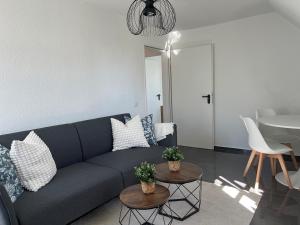 a living room with a couch and two tables at Charming apartment central in Lucerne in Lucerne