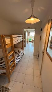 a room with a bunk bed and a hallway at Le Jean Bart front de mer in Le Crotoy