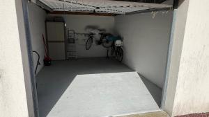 a garage with two bikes parked in it at Le Jean Bart front de mer in Le Crotoy