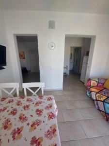 a living room with a bed and a couch at Su Furriadroxiu in San Vito