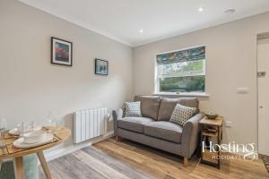 a living room with a couch and a table at The Courtyard Apartments - Thyme in Henley on Thames