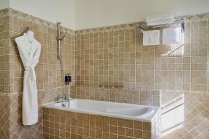 a bathroom with a bath tub and a sink at Hotel Le Grimaldi by Happyculture in Nice +141 photos