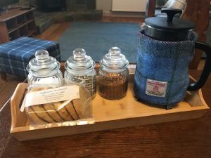 a tray with jars and a tea pot and bread at Belmont Chapel Cottage in Acharacle +65 photos