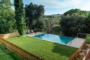 an image of a swimming pool in a yard at Casa rural El Bruguer Vell in Santa Eulalia de Ronsaná
