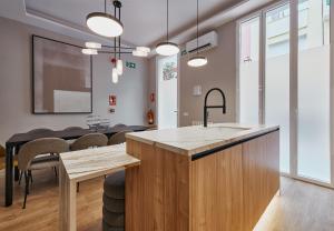 a kitchen and dining room with a table and chairs at Fuencarral Living 7BR 7BH in Madrid +33 photos