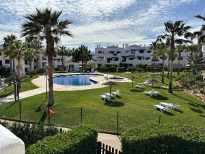 a resort with a pool and palm trees and buildings at Salinalux Vera Playa in Vera