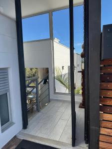 a sliding glass door on a balcony with a view at Mountain Home Close to Guatape Pueblo With Jacuzzi in Guatapé