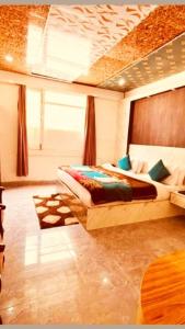 a bedroom with two beds and a large window at Hotel New Urvashi in Jāmb
