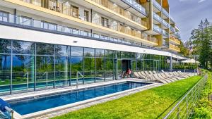 an external view of a building with a swimming pool at Złoty Horyzont VIP - główny budynek - z basenem, siłownią, grotą solną, bawialnią i restauracją by Royal Aparts in Szklarska Poręba