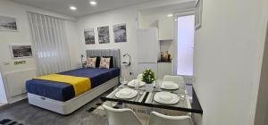a bedroom with a bed and a table and chairs at Apartamento Cavaleiro in Nazaré +23 photos
